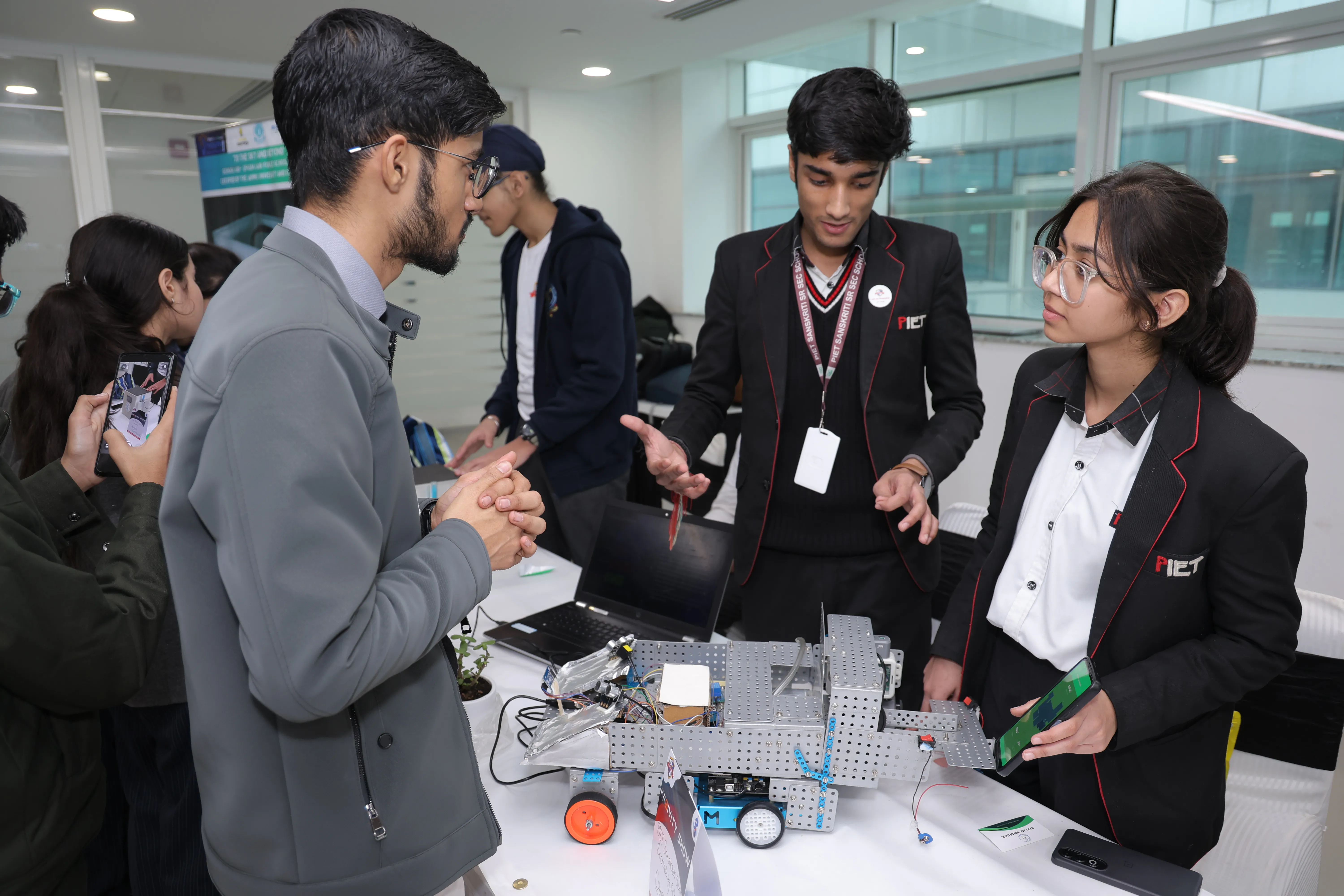 Students presenting robotics project to judges
