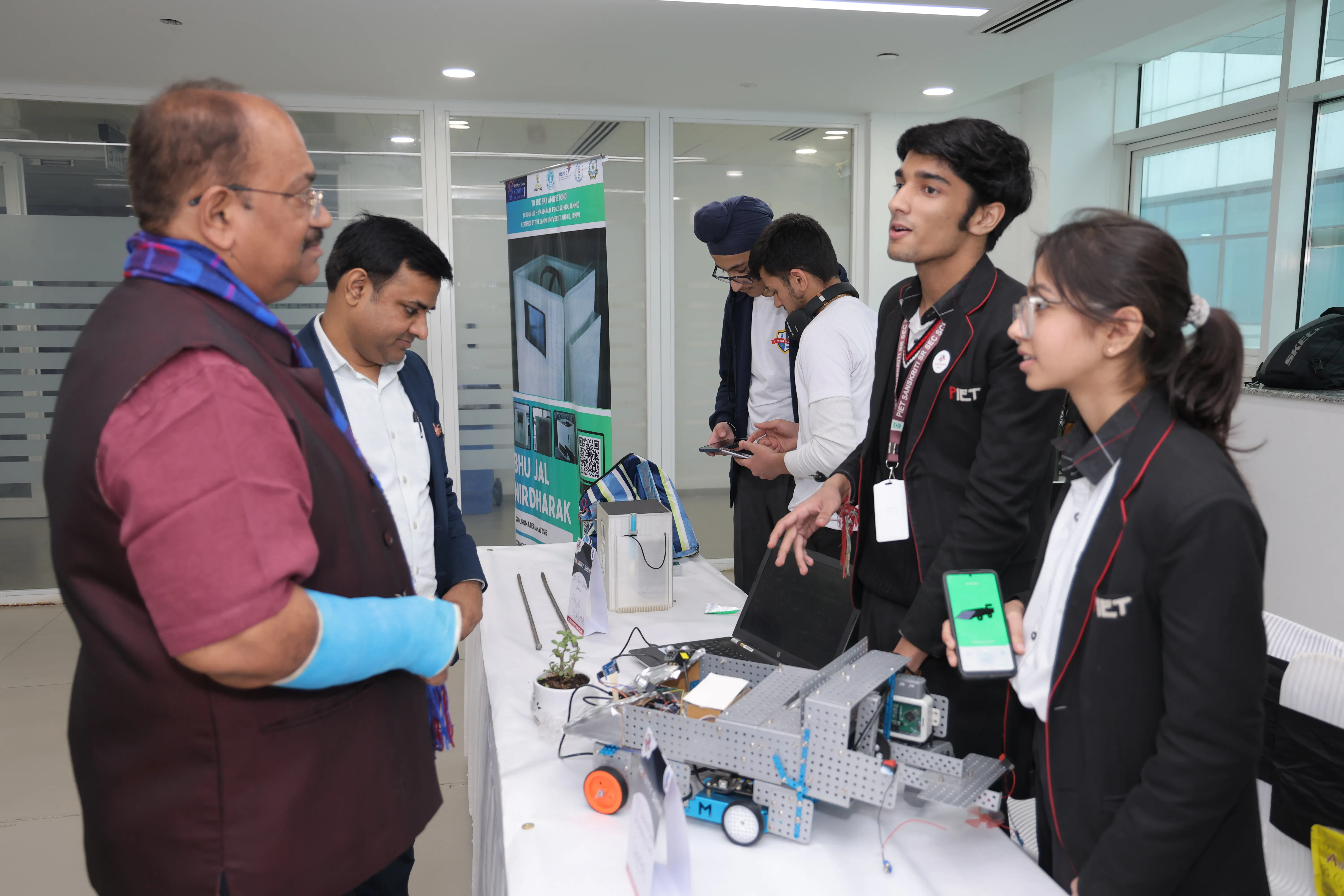 Students demonstrating robotics project to judges